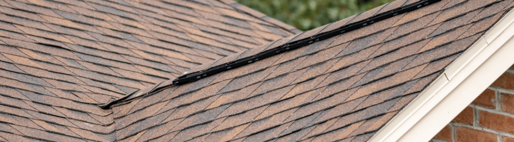 Close up of new roof shingles with a red tint
