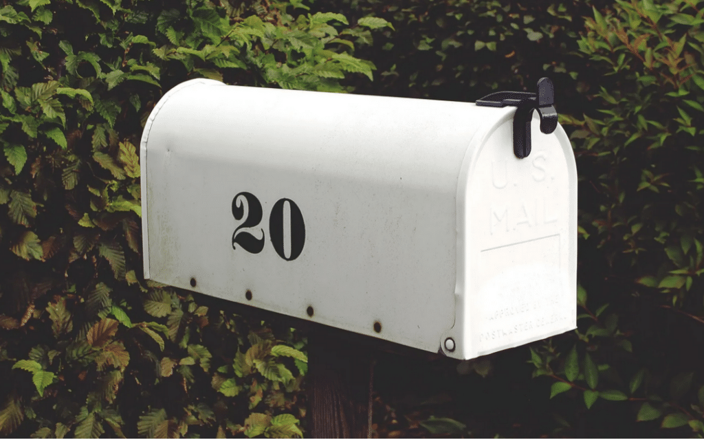 A white mailbox with a black handle and a black number 20 on the side