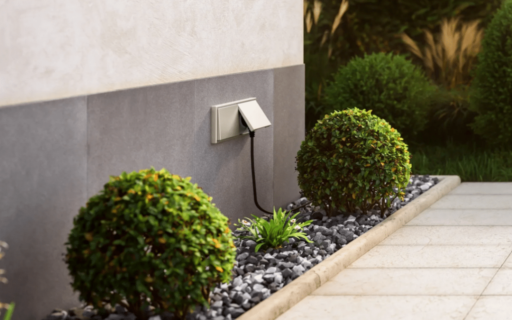An outdoor electrical outlet along a nicely landscaped path