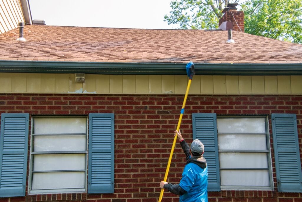a person is cleaning a roof
