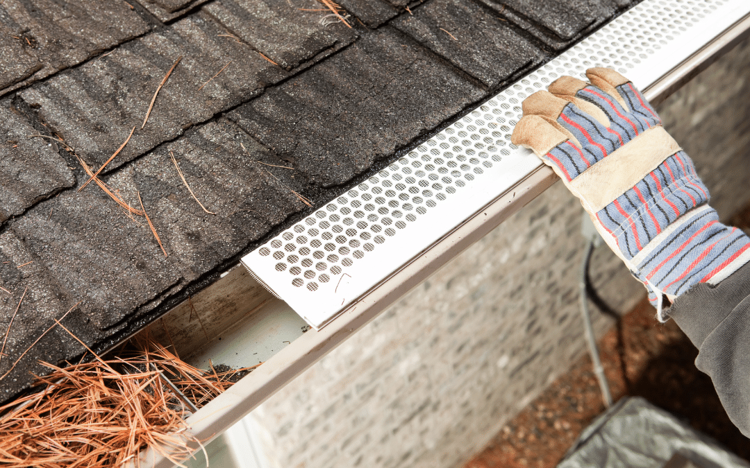 A person installing gutter guards