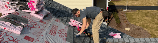 Roofer replacing a shingle roof